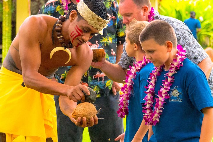 Man giving coconut demonstration to child