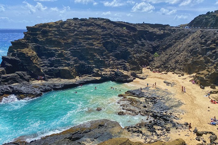 Aerial view of rocky coastline with beach and waves