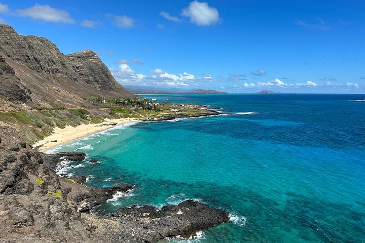 Aerial view of a crescent beach and turquoise bay