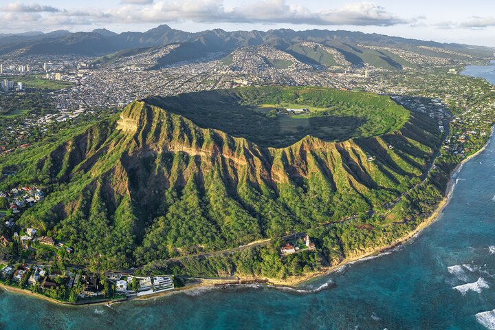 Aerial view of a green ridged mountain and coast