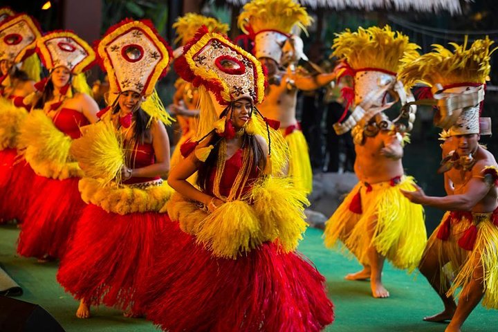 Hula dancers in yellow and red costumes