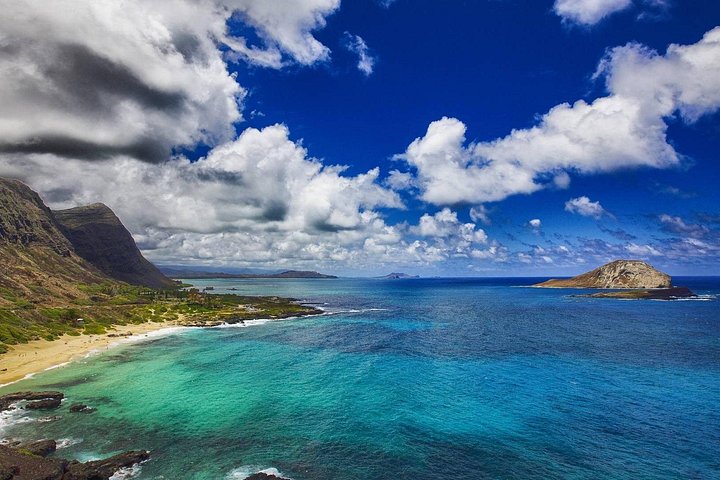 Aerial view of coastline with green hills